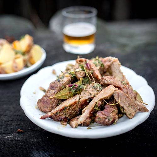Grilled pork with roasted potato and pepper salad with mustard dressing